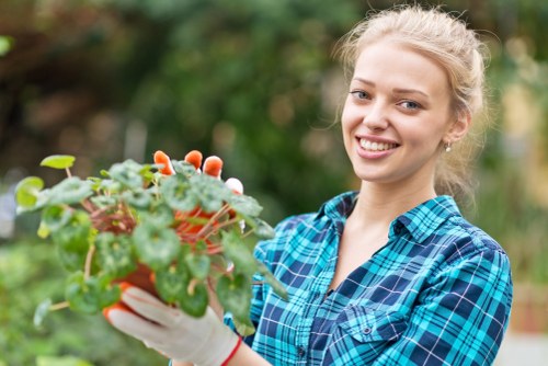 Gardener carrying out safe outdoor maintenance with protective equipment